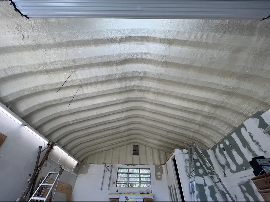 Spray polyurethane foam applied to the underside of a metal roof deck in Huntington